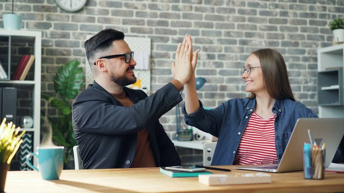 Two people happy achieving their goals