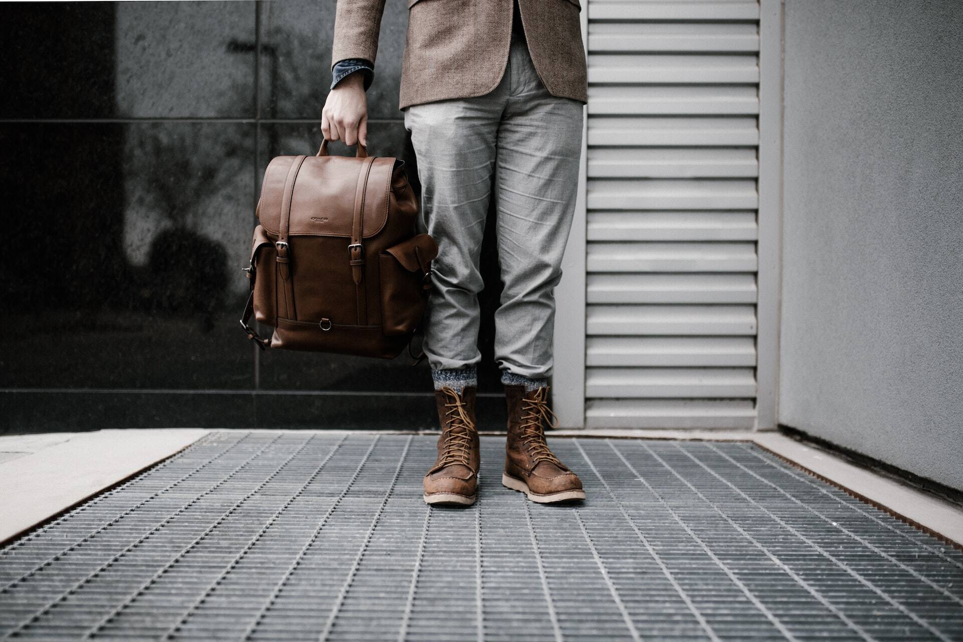 guy holding a backpack in his hand