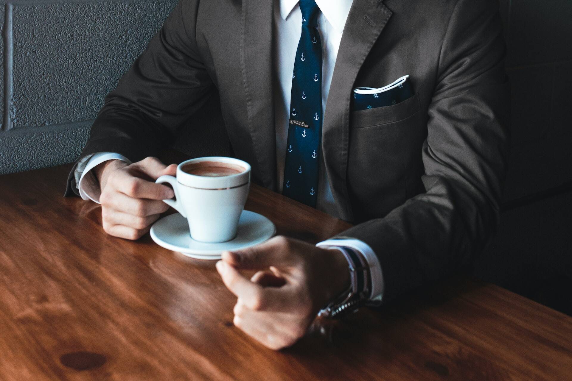 guy in a suit drinking coffee