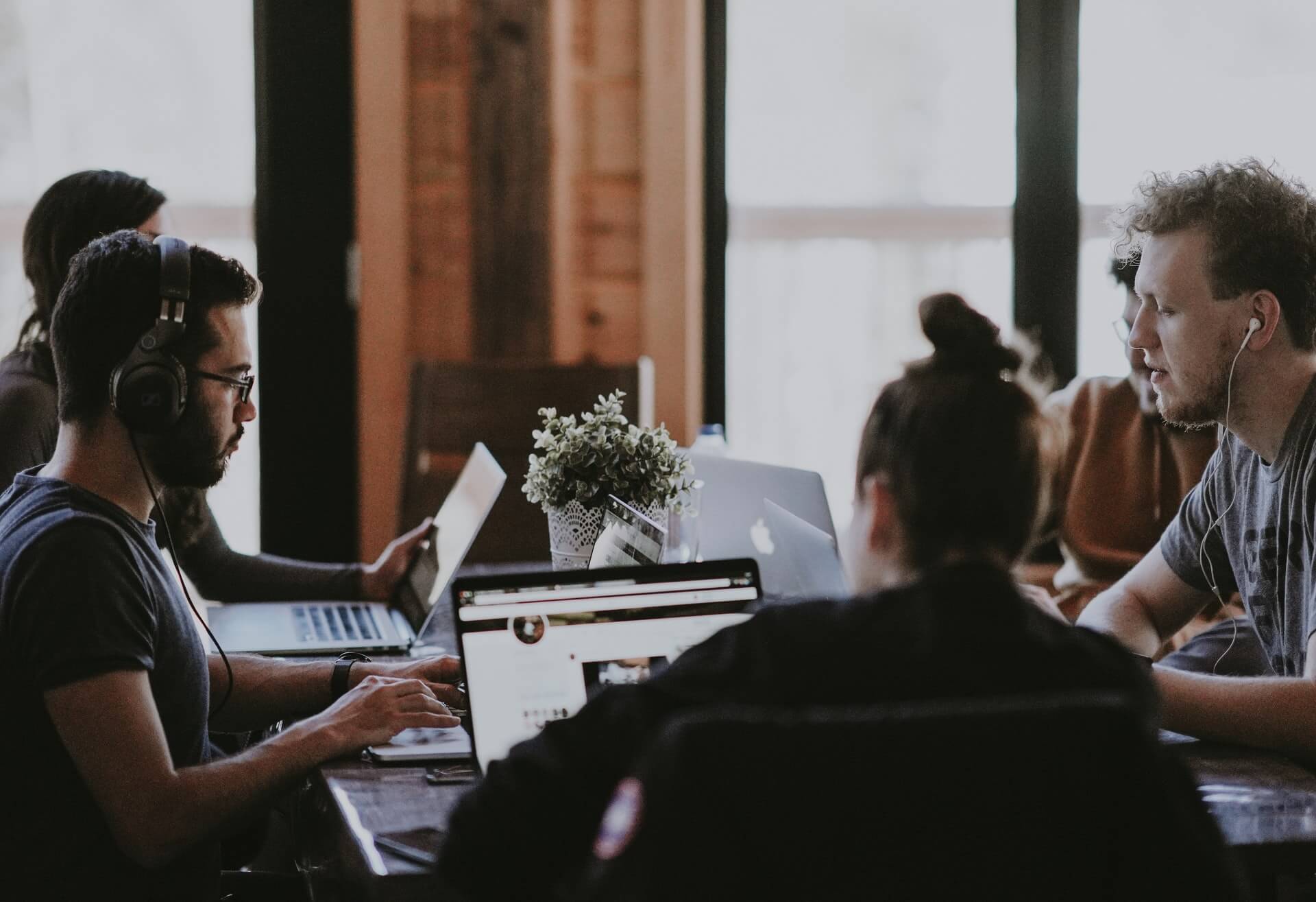 five people working together in a quiet room