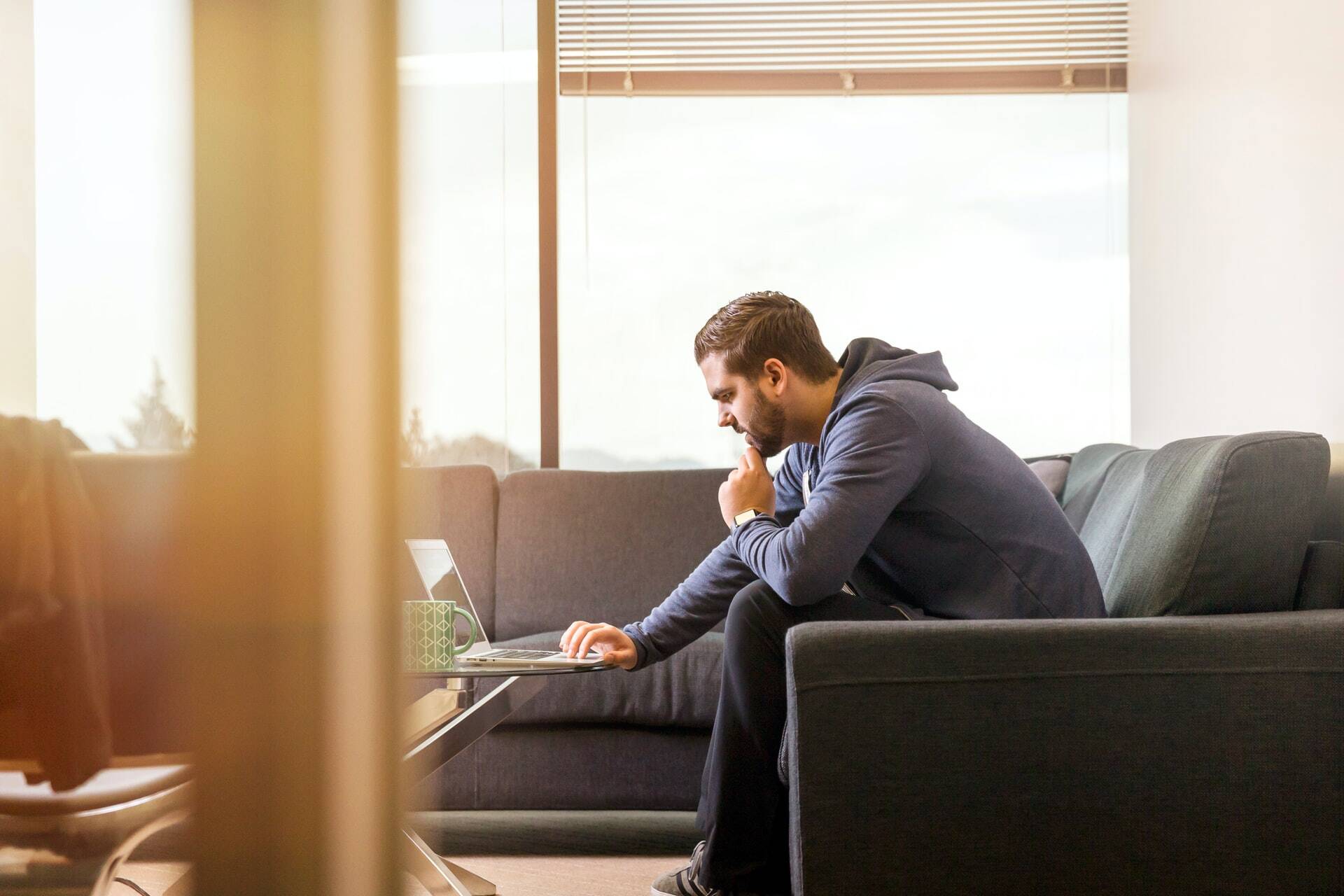 Man sitting in a sofa and working in a computer