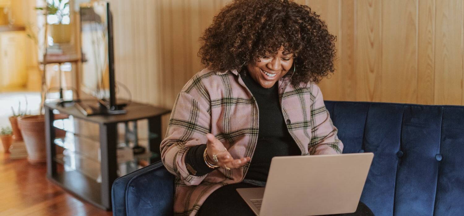 Happy woman looking at something in a computer