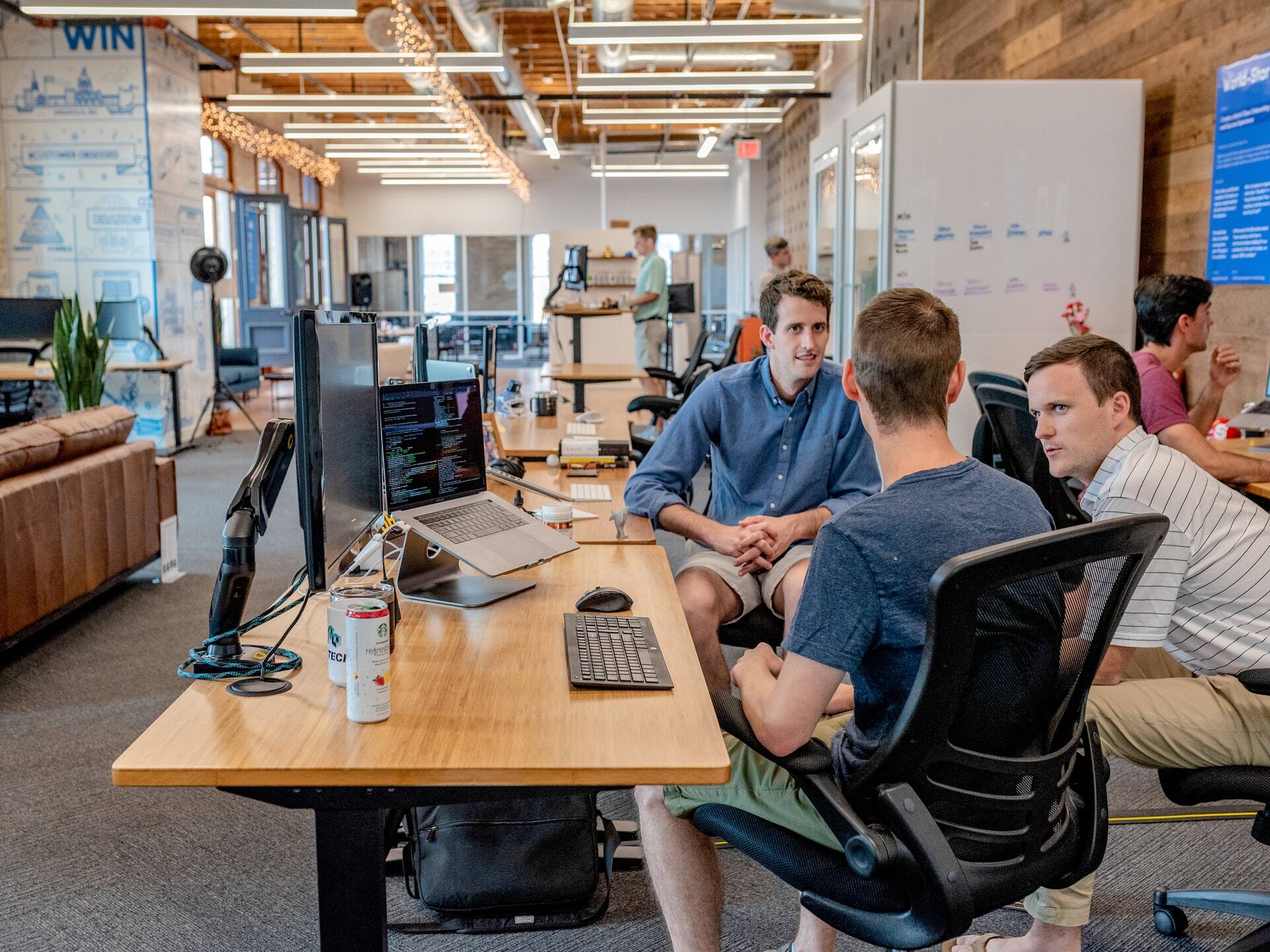 Three men speaking at office