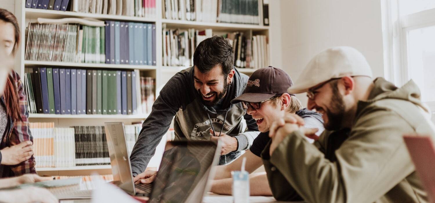 Two happy people seeing something in a computer