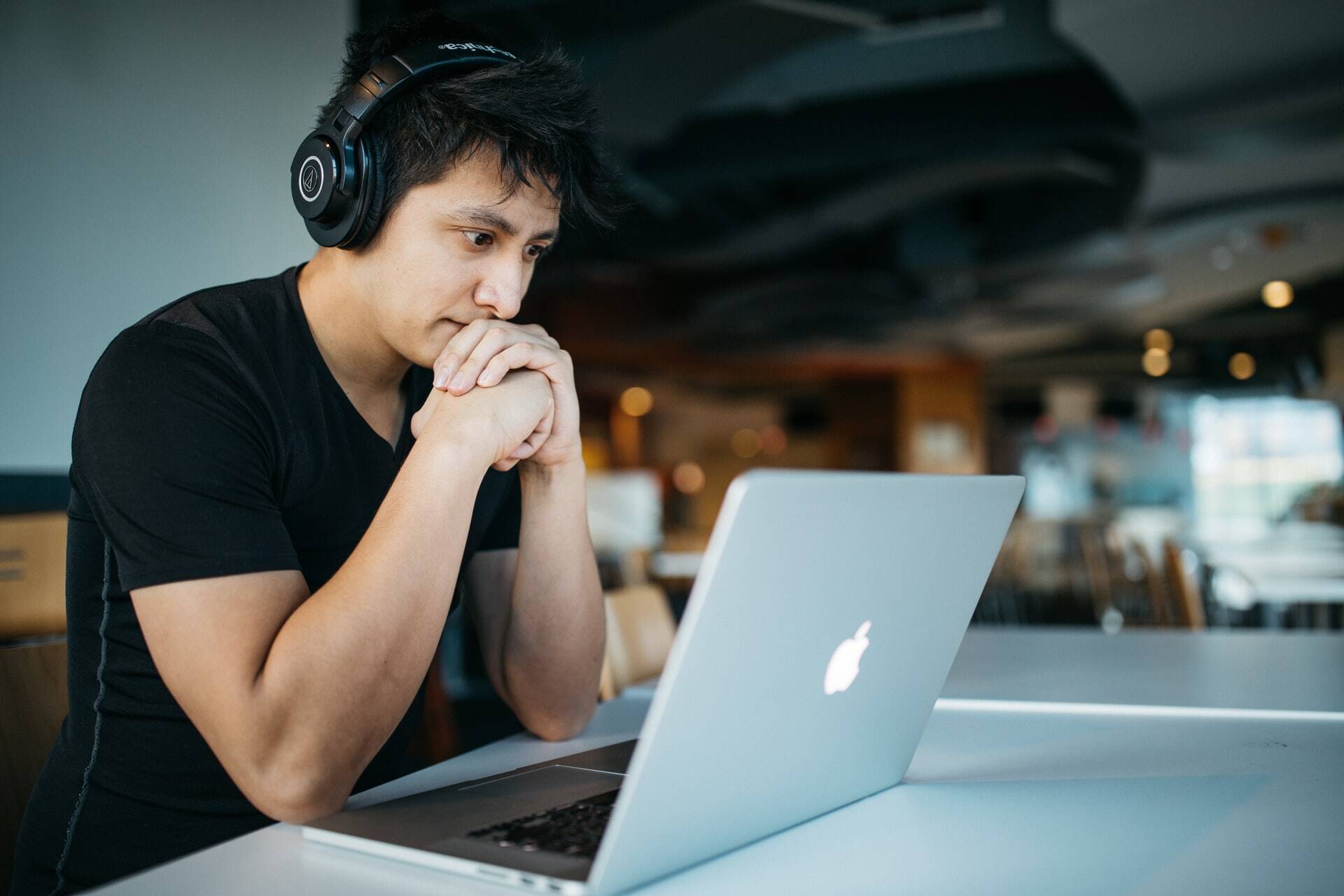 Man paying attention at something in a Macbook