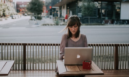 Woman working in a Macbook outdoor