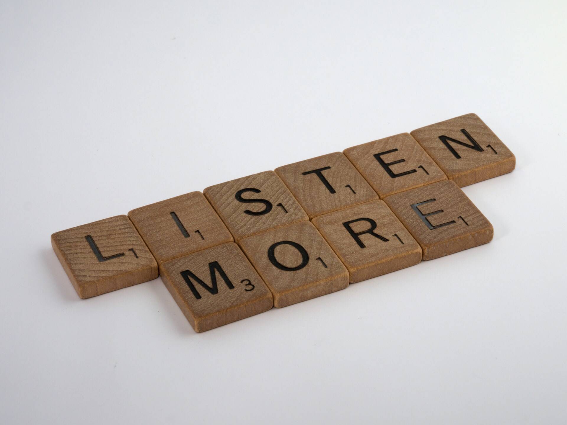 Listen more written with wood blocks