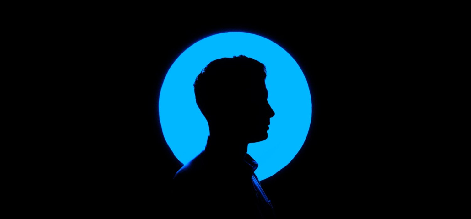 Dark silhouette in a round blue symbol