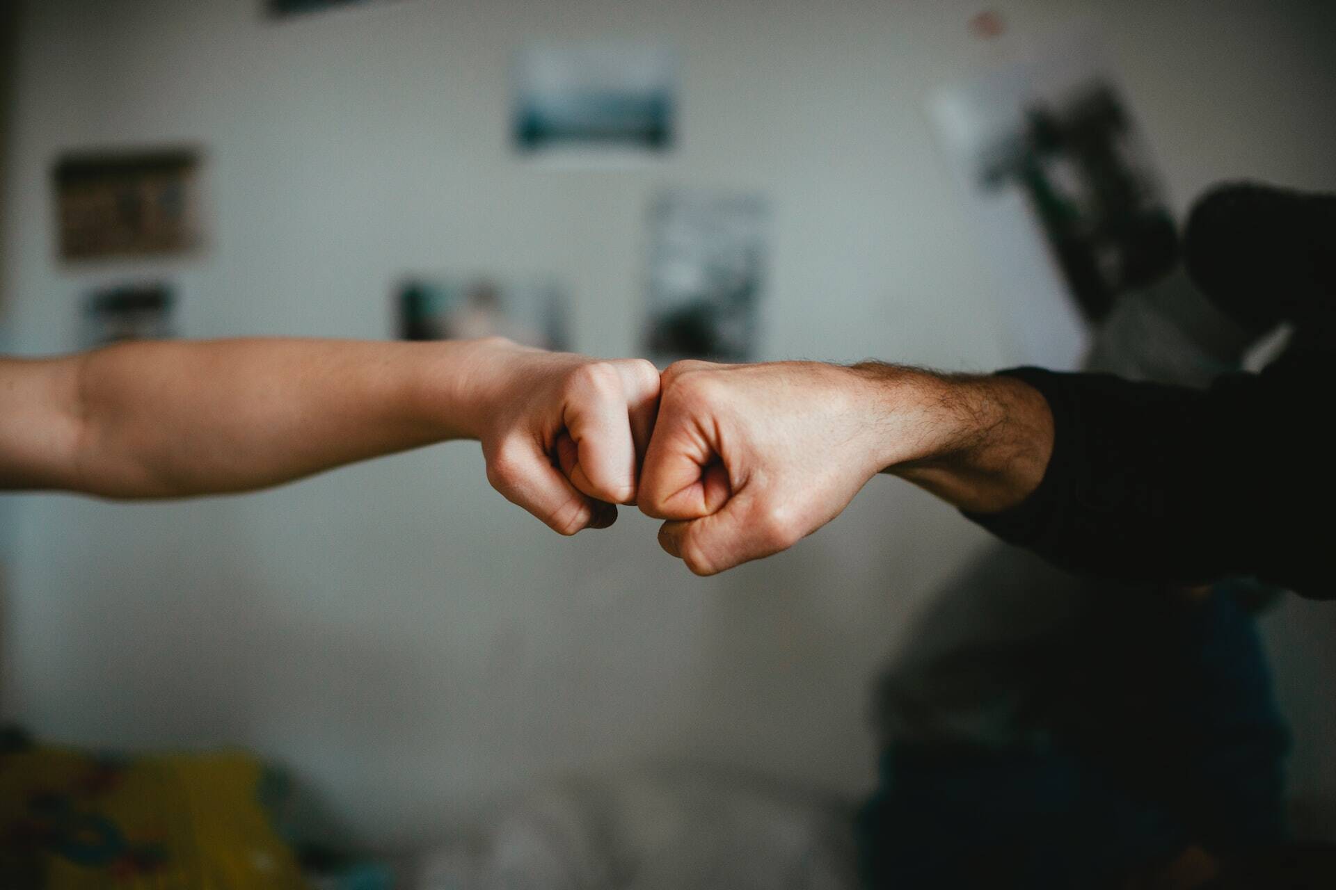 Two people bumping fists