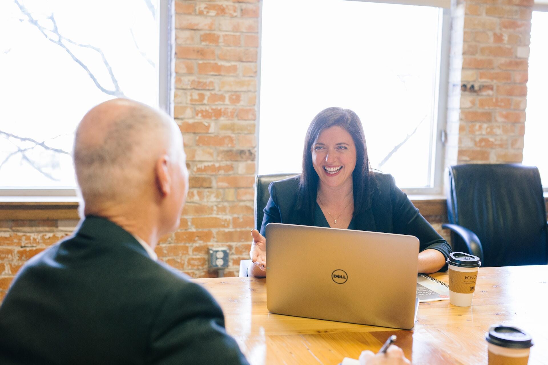 Two happy people speaking in a meeting