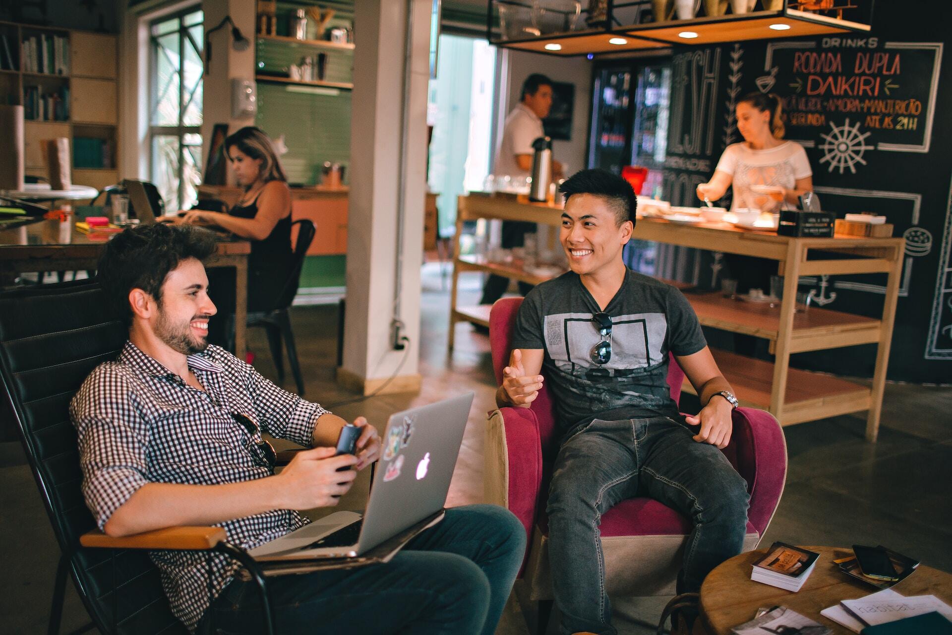 Two men talking in a co-work station