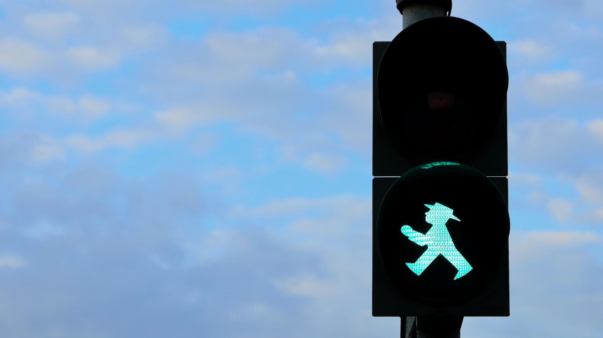 A pedestrian traffic signal green