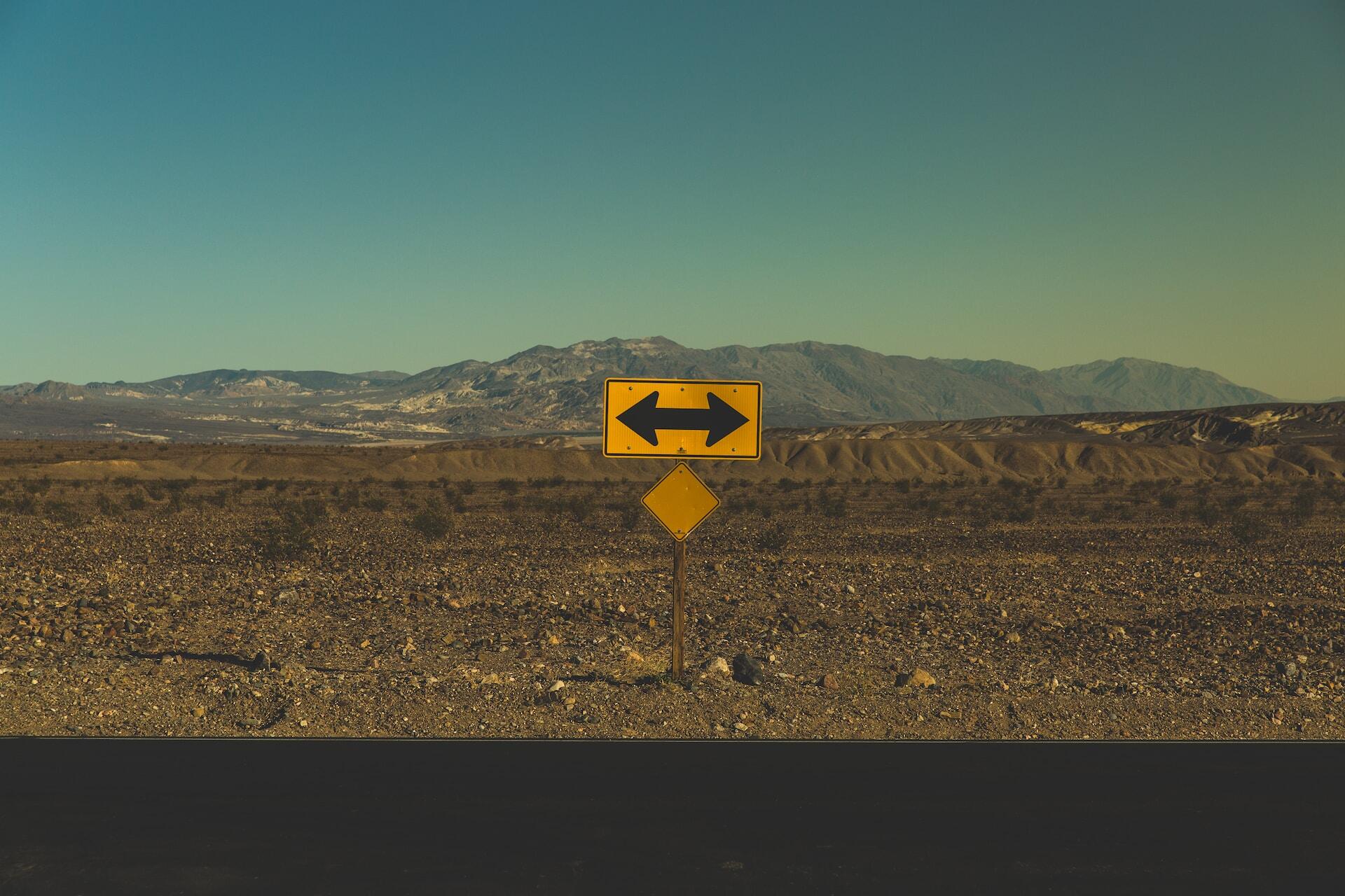 Road sign with arrows pointing to right and left at the same time