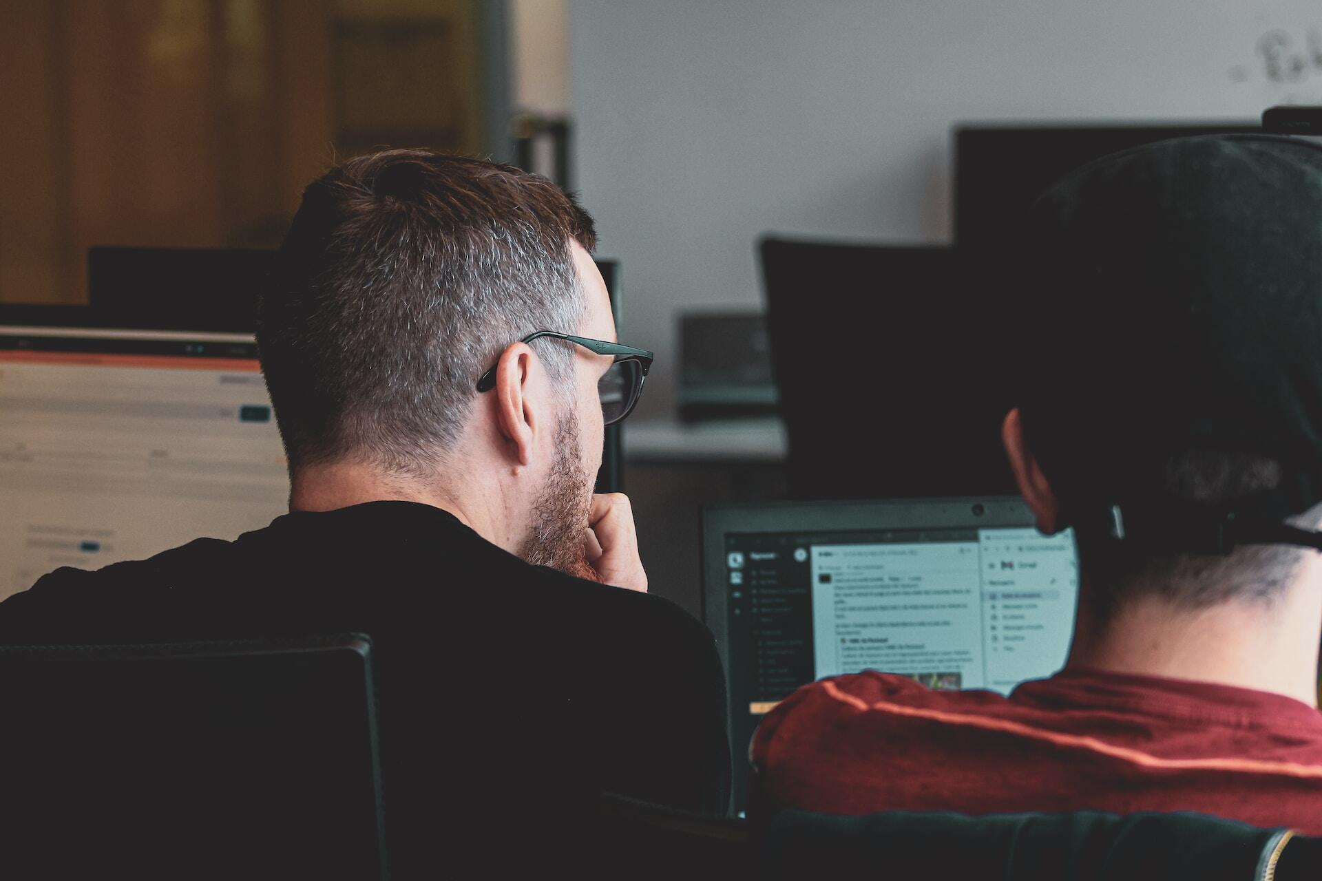 Two men looking at a computer screen