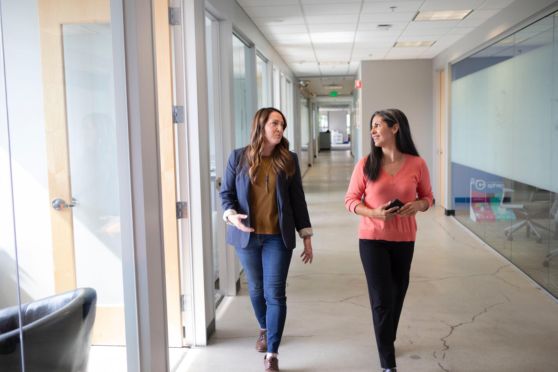 Two women walking and talking