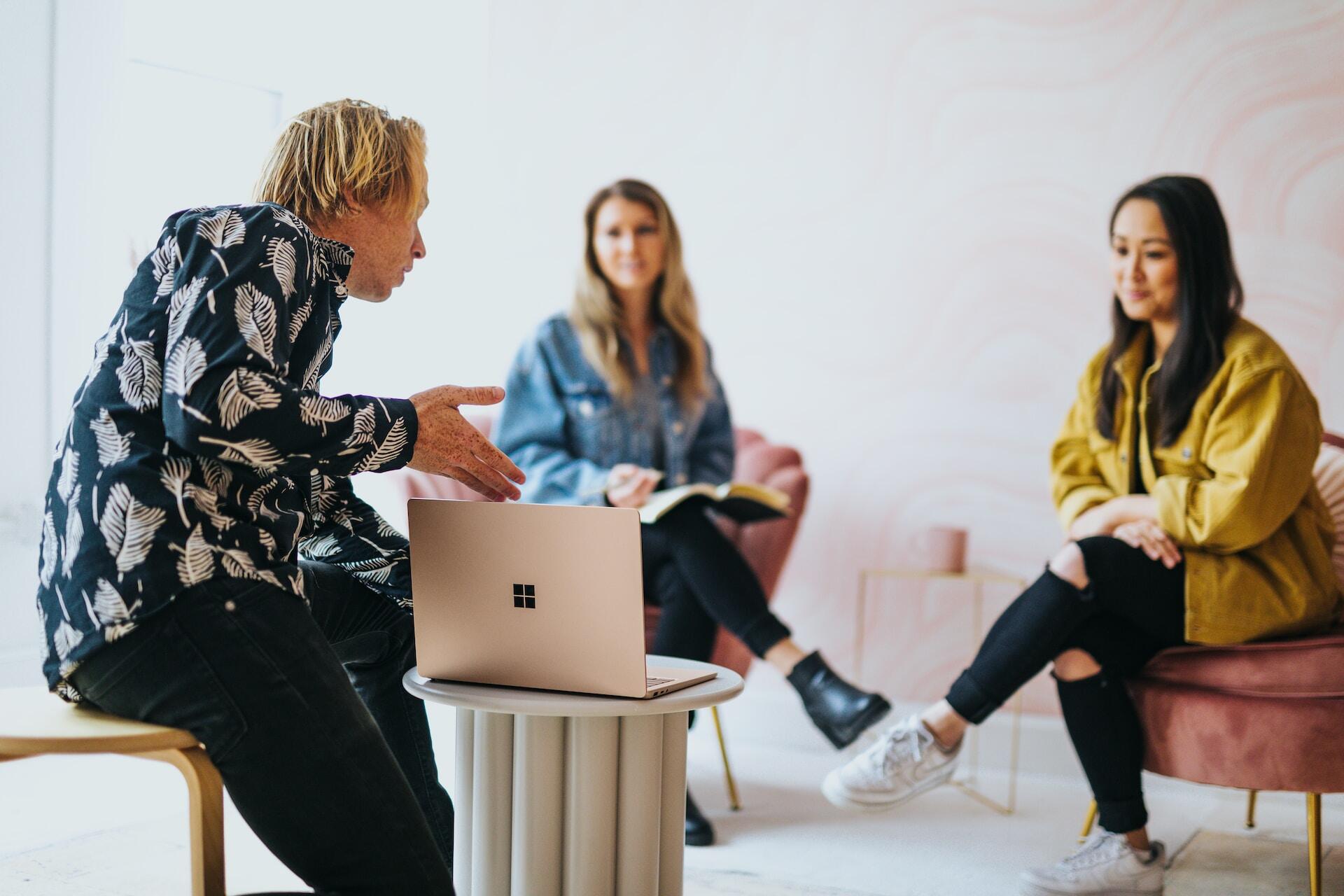 Three people discussing a presentation